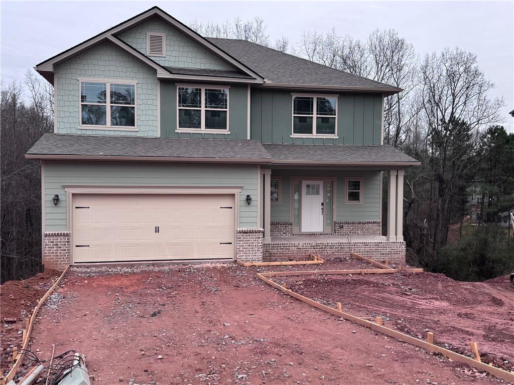 484 Magnolia Grove Place Cornelia, GA 30531 - Photo 2 of 35 a front view of a house with a yard and garage