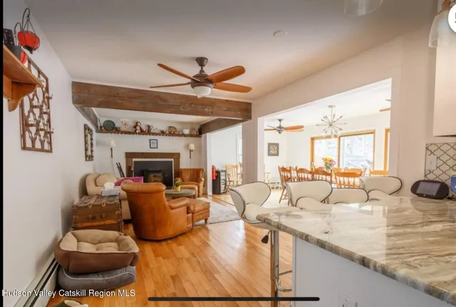 a living room with fireplace furniture and a large window