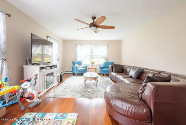 a living room with furniture and a flat screen tv