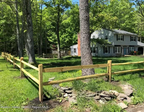 a view of house with a yard