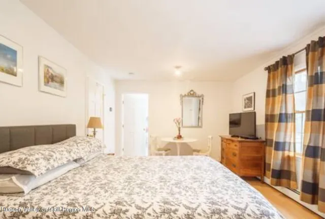 a bedroom with a bed and a flat screen tv