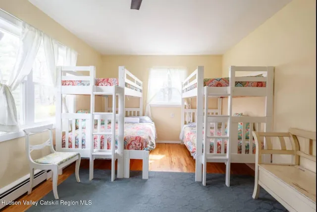 a bedroom with furniture and a large window