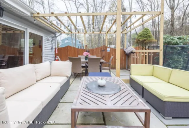 a outdoor space with patio the couches and a dining table with large trees