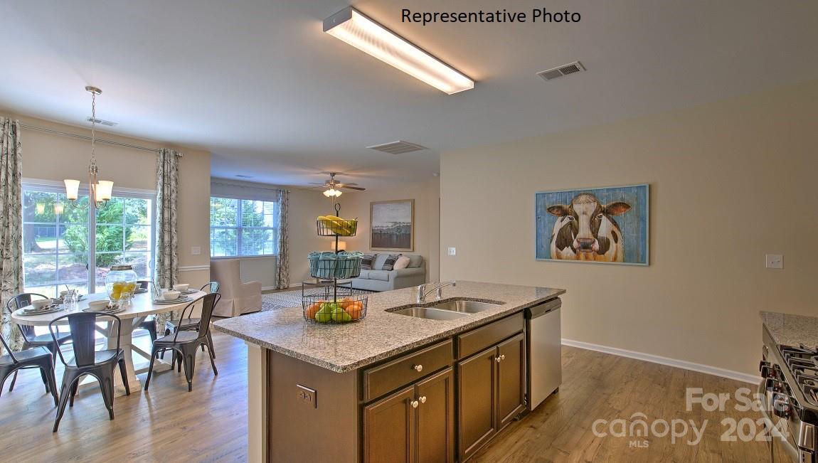 3779 Charles Street Northwest Conover, NC 28613 - Photo 13 of 36 a view of a kitchen area with furniture and wooden floor
