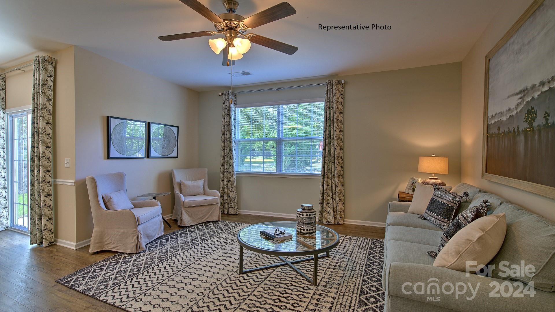 3779 Charles Street Northwest Conover, NC 28613 - Photo 16 of 36 a living room with furniture a window and a chandelier