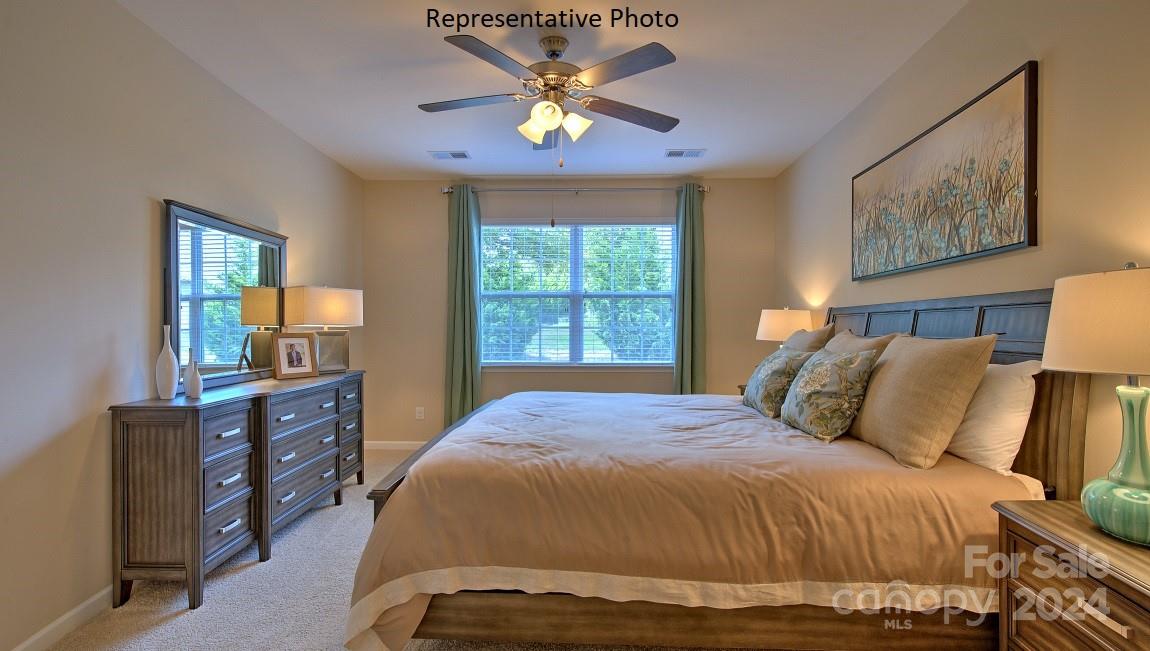 3779 Charles Street Northwest Conover, NC 28613 - Photo 33 of 36 a bedroom with a bed and a chandelier