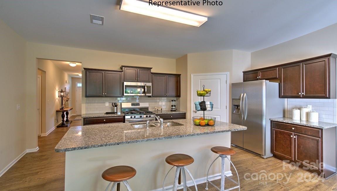 3779 Charles Street Northwest Conover, NC 28613 - Photo 5 of 36 a kitchen with stainless steel appliances granite countertop a sink refrigerator and microwave