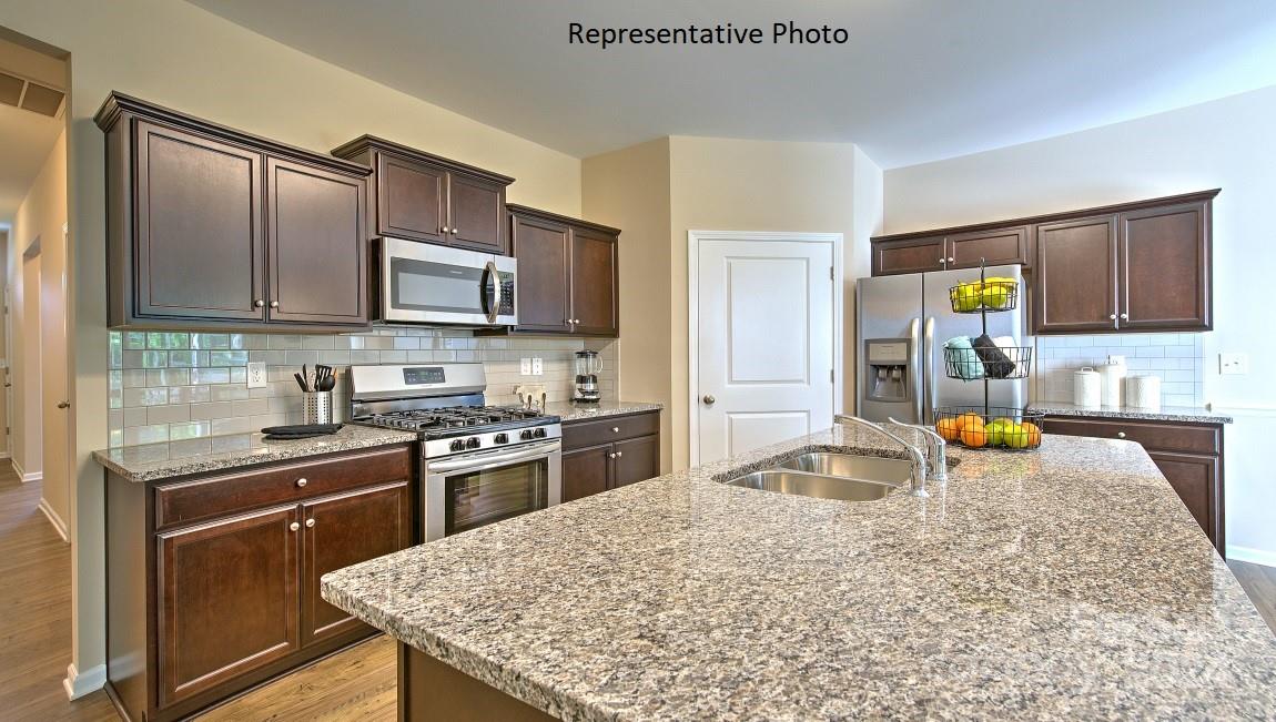 3779 Charles Street Northwest Conover, NC 28613 - Photo 9 of 36 a kitchen with stainless steel appliances granite countertop a sink stove and refrigerator