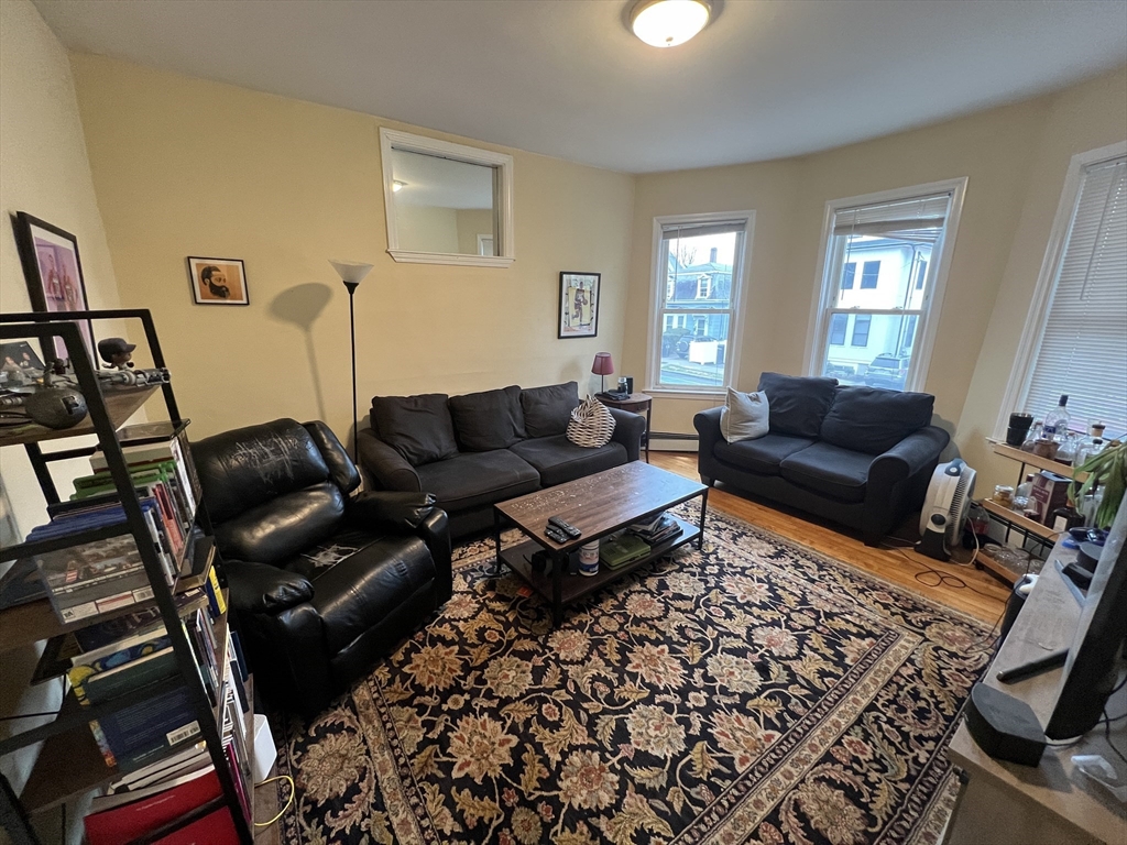 29 Cameron Avenue, Unit 1 Somerville, MA 02144 - Photo 1 of 16 a living room with furniture and a couch