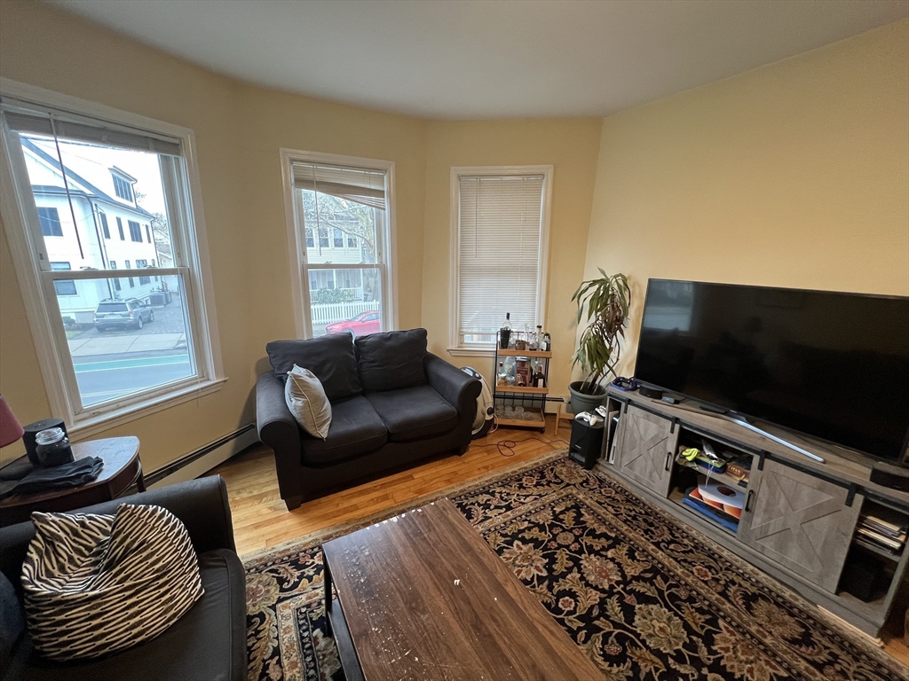 29 Cameron Avenue, Unit 1 Somerville, MA 02144 - Photo 2 of 16 a living room with furniture and a flat screen tv