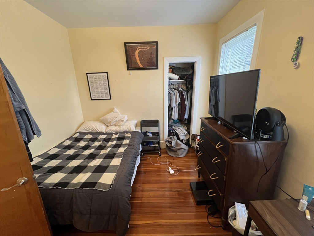 29 Cameron Avenue, Unit 1 Somerville, MA 02144 - Photo 6 of 16 a bedroom with a bed and wooden floor