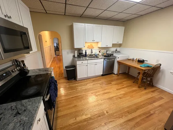 a kitchen with a sink appliances and cabinets