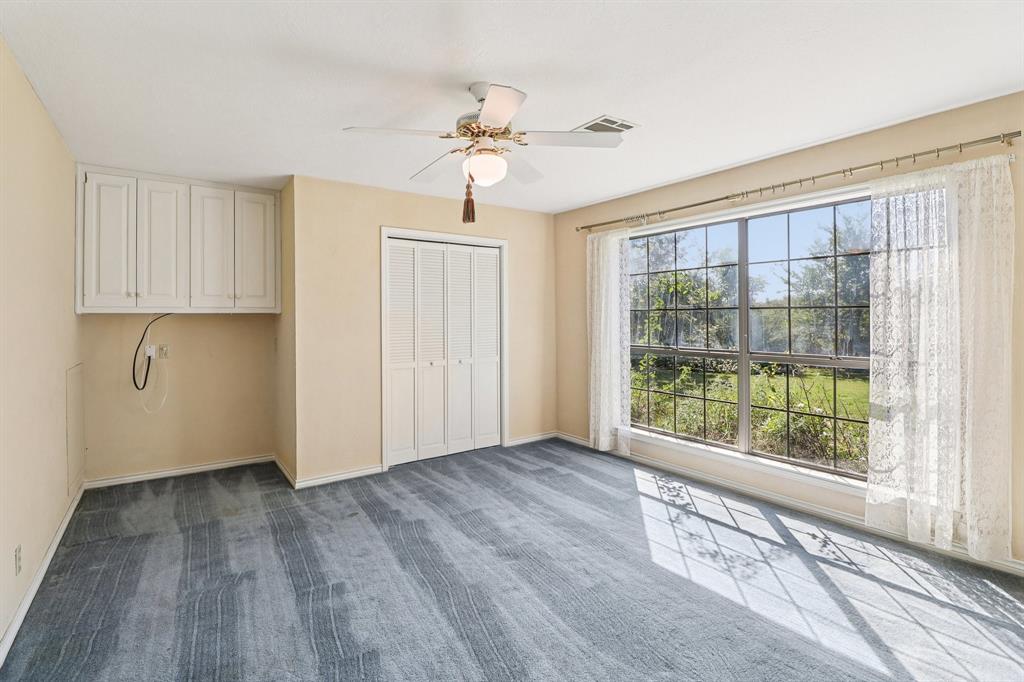 329 Lowell Road Milford, TX 76670 - Photo 12 of 40 a view of an empty room with a window and wooden floor
