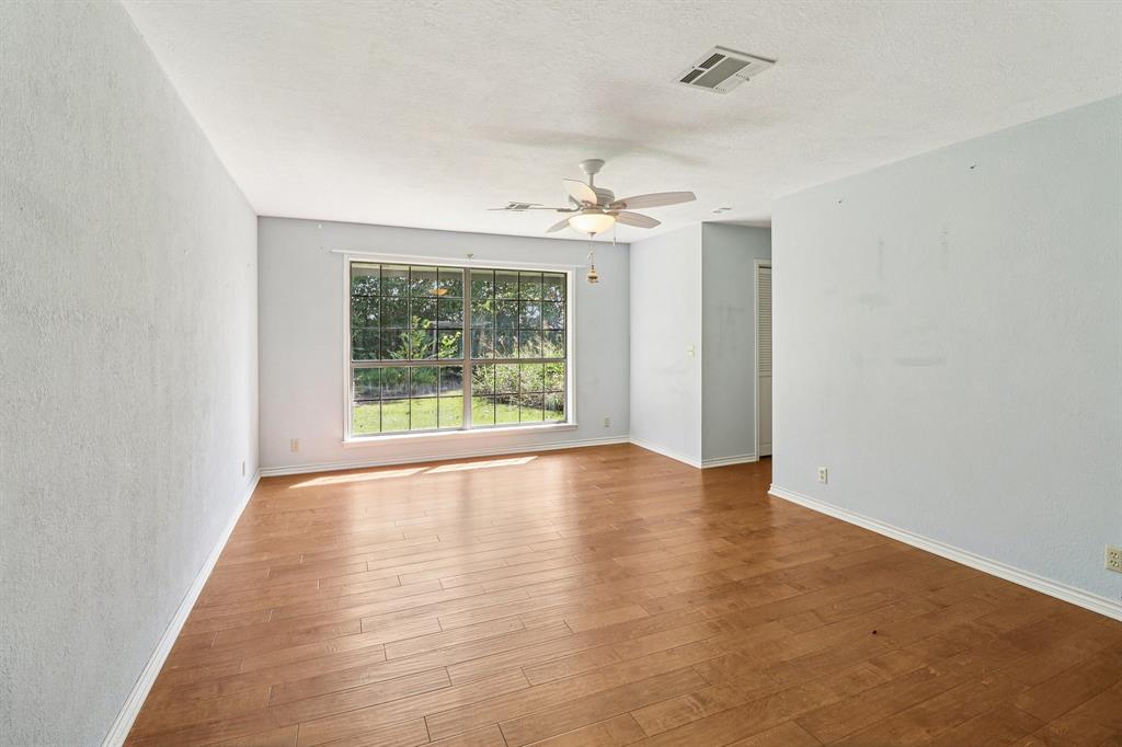 329 Lowell Road Milford, TX 76670 - Photo 9 of 40 wooden floor in an empty room with a window