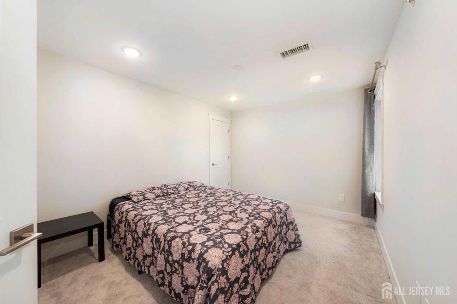 707 Station Road Dunellen, NJ 08812 - Photo 15 of 28 a bedroom with a bed and a dresser