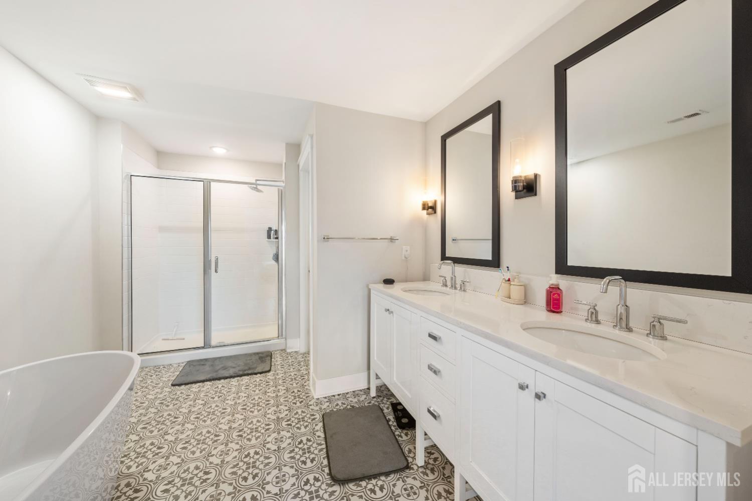 707 Station Road Dunellen, NJ 08812 - Photo 18 of 28 a bathroom with a double vanity sink mirror and shower