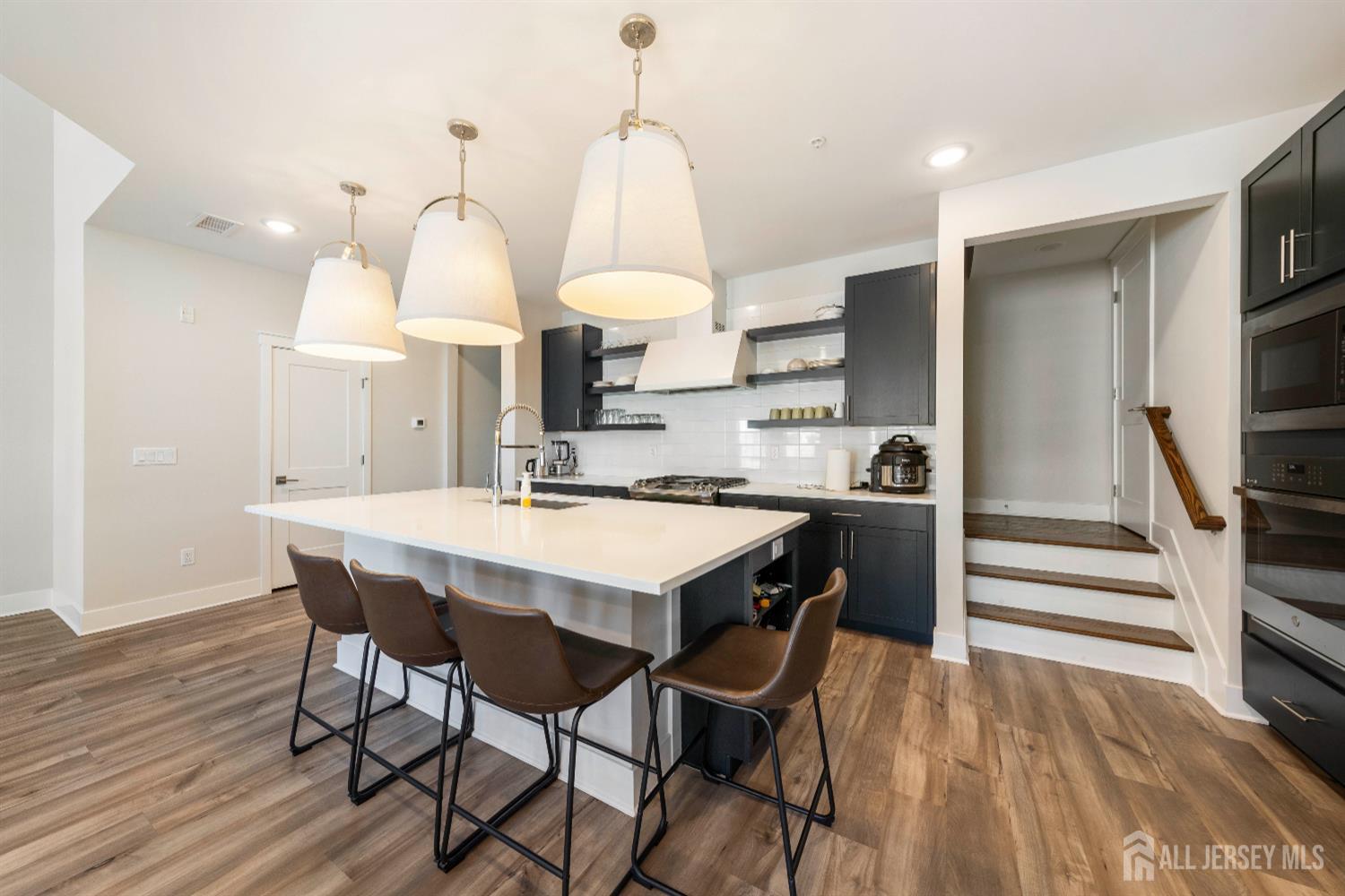 707 Station Road Dunellen, NJ 08812 - Photo 6 of 28 a kitchen with a table chairs stove and cabinets
