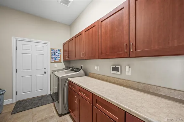a view of a storage and utility room with washer and dryer