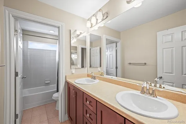 a bathroom with a sink double vanity granite tub and shower