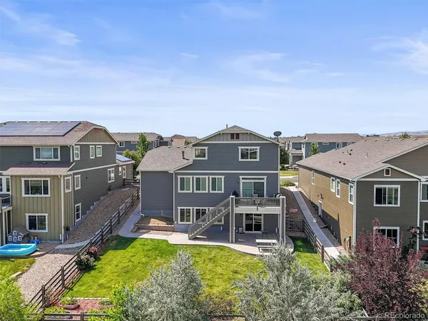 a aerial view of a house with swimming pool lawn chairs and a yard
