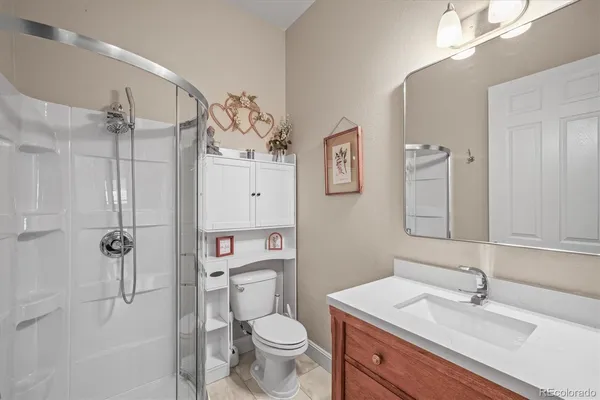 a bathroom with a sink toilet tub and shower