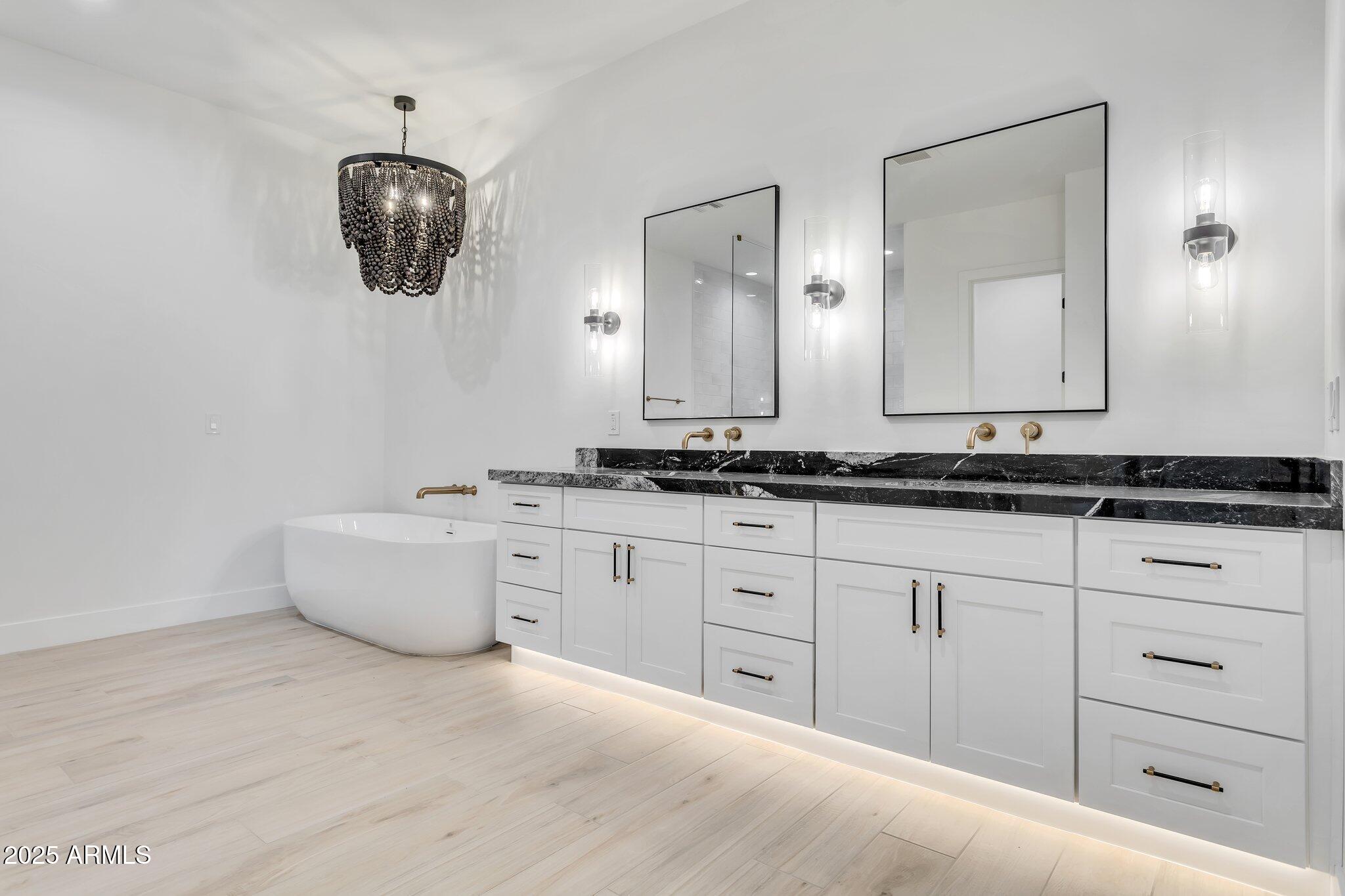 1602 East Cloud Road Phoenix, AZ 85086 - Photo 4 of 45 a bathroom with a tub sink and mirror