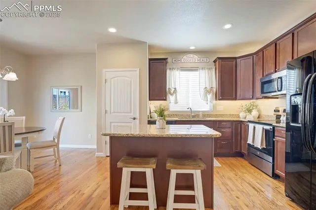 a kitchen with granite countertop a sink appliances and cabinets