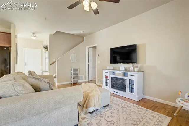 a spacious bedroom with a bed and a flat screen tv