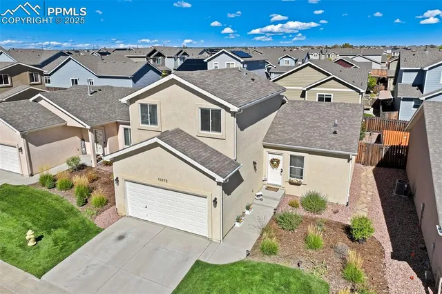 an aerial view of residential houses with outdoor space