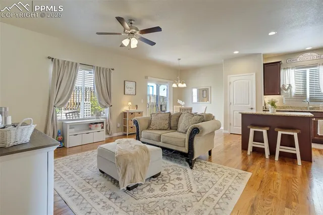 a living room with furniture and a wooden floor