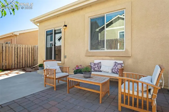 a backyard of a house with outdoor seating