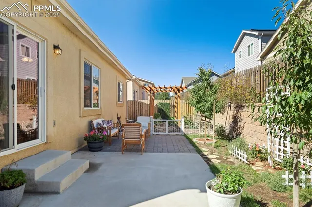 a view of a patio with couches and table and chairs next to a yard
