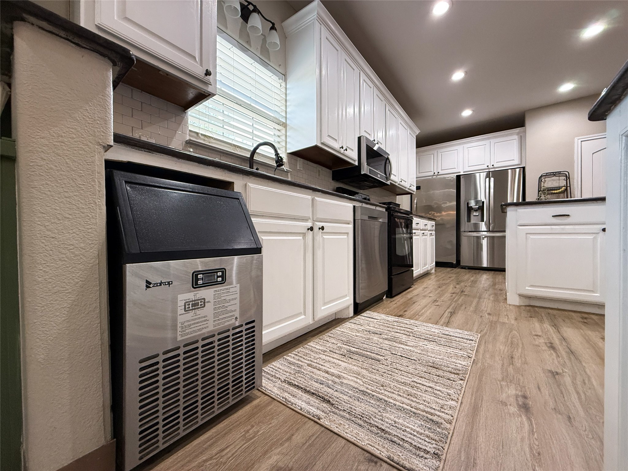 740 Bridget Avenue Buffalo, TX 75831 - Photo 27 of 50 a kitchen with stainless steel appliances granite countertop a refrigerator a stove and a wooden floors