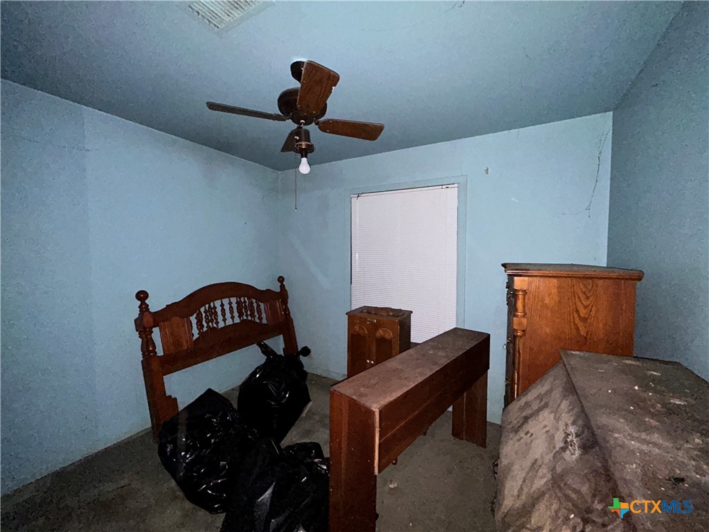 210 Travis Street Port Lavaca, TX 77979 - Photo 6 of 10 a bedroom with furniture and a ceiling fan