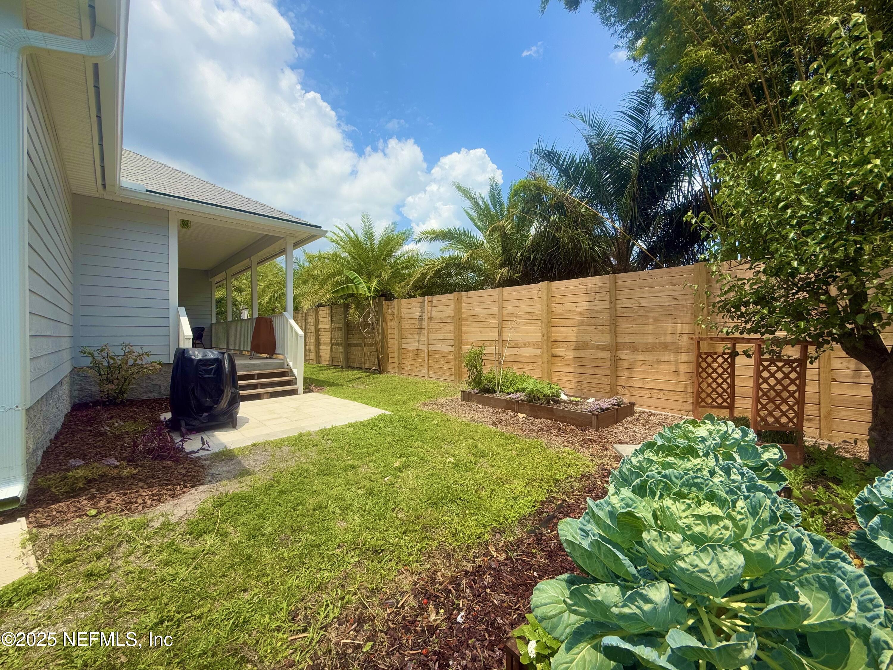 330 Trade Wind Lane St. Augustine, FL 32080 - Photo 34 of 46 a view of backyard with a garden and plants