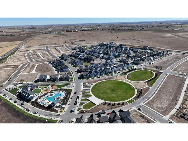 an aerial view of a house with a swimming pool outdoor seating and yard
