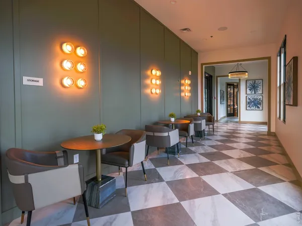 a living room with furniture and potted plants