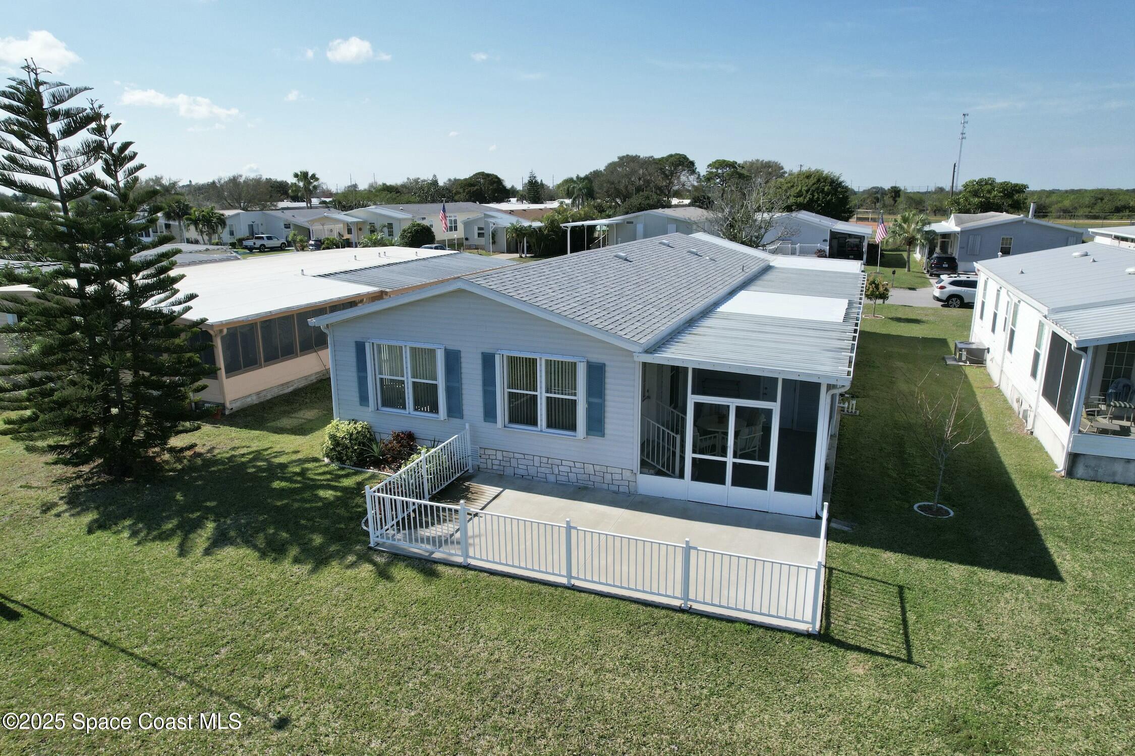 1124 Barefoot Circle Barefoot Bay, FL 32976 - Photo 14 of 79 a aerial view of a house with a yard