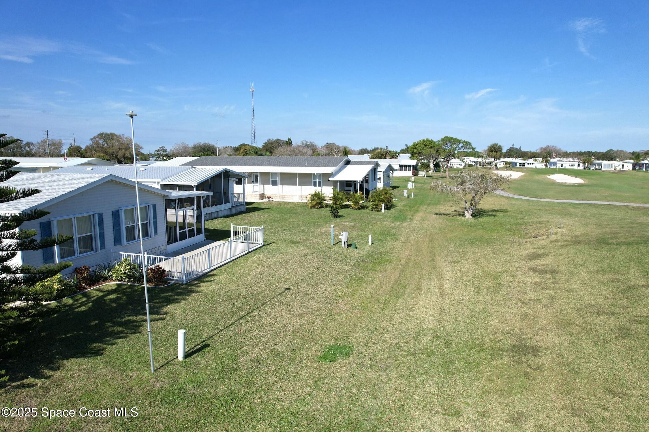 1124 Barefoot Circle Barefoot Bay, FL 32976 - Photo 16 of 79 a view of a house with a yard