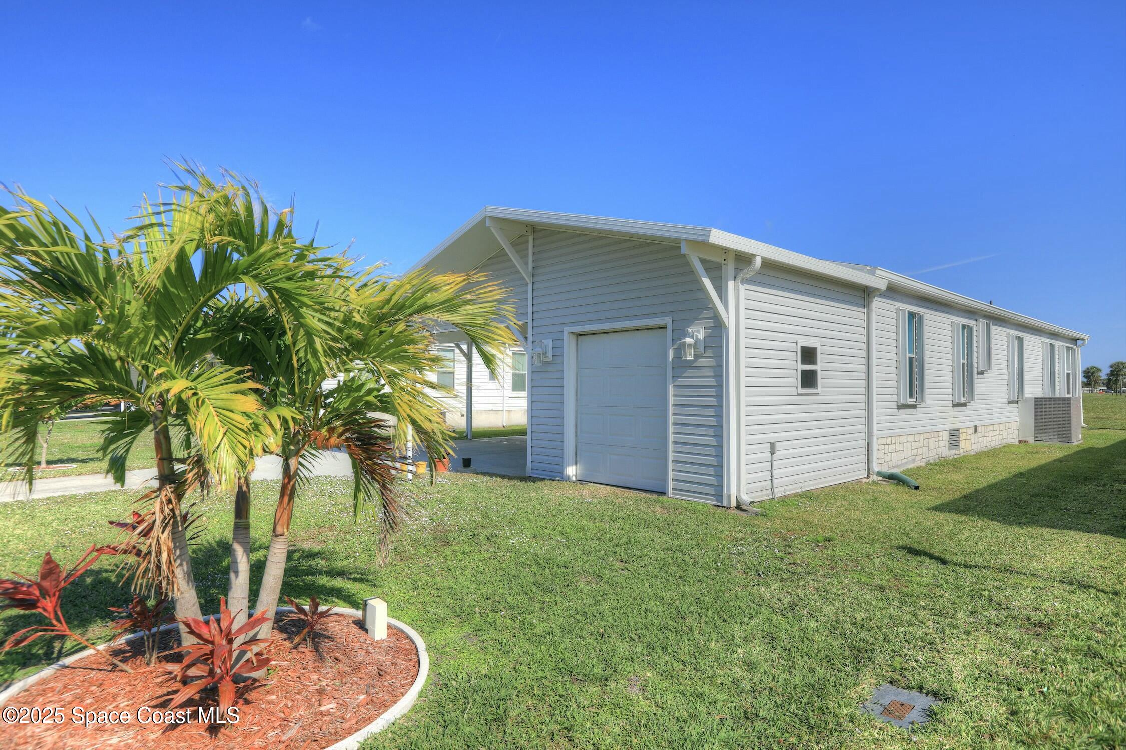 1124 Barefoot Circle Barefoot Bay, FL 32976 - Photo 18 of 79 a backyard of a house with barbeque oven table and chairs