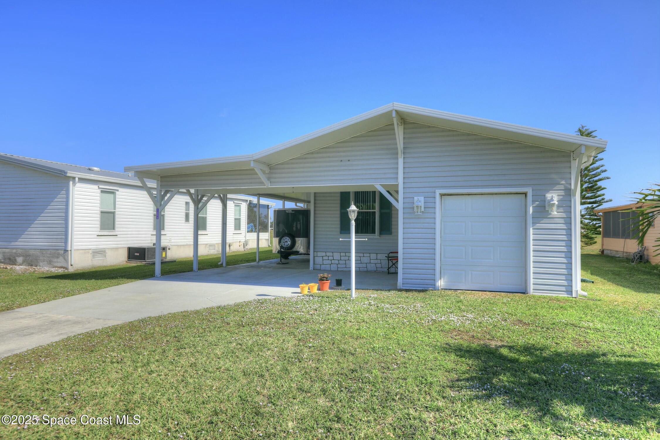 1124 Barefoot Circle Barefoot Bay, FL 32976 - Photo 19 of 79 a view of a house with a yard and pathway