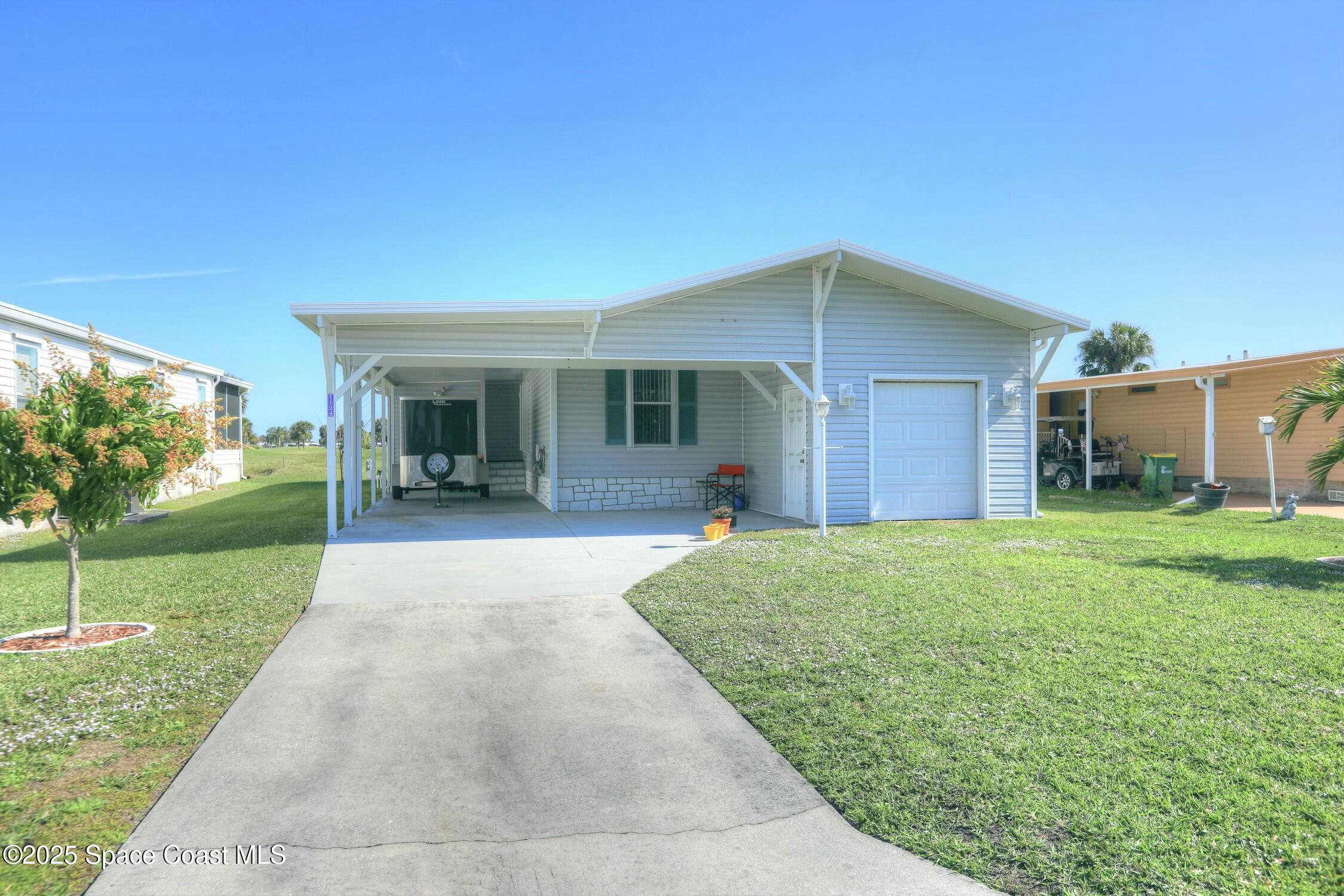 1124 Barefoot Circle Barefoot Bay, FL 32976 - Photo 20 of 79 a view of a house with backyard and garden