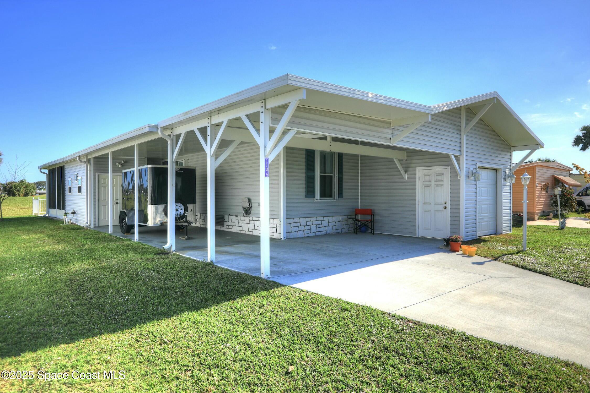 1124 Barefoot Circle Barefoot Bay, FL 32976 - Photo 22 of 79 a view of a house with garden