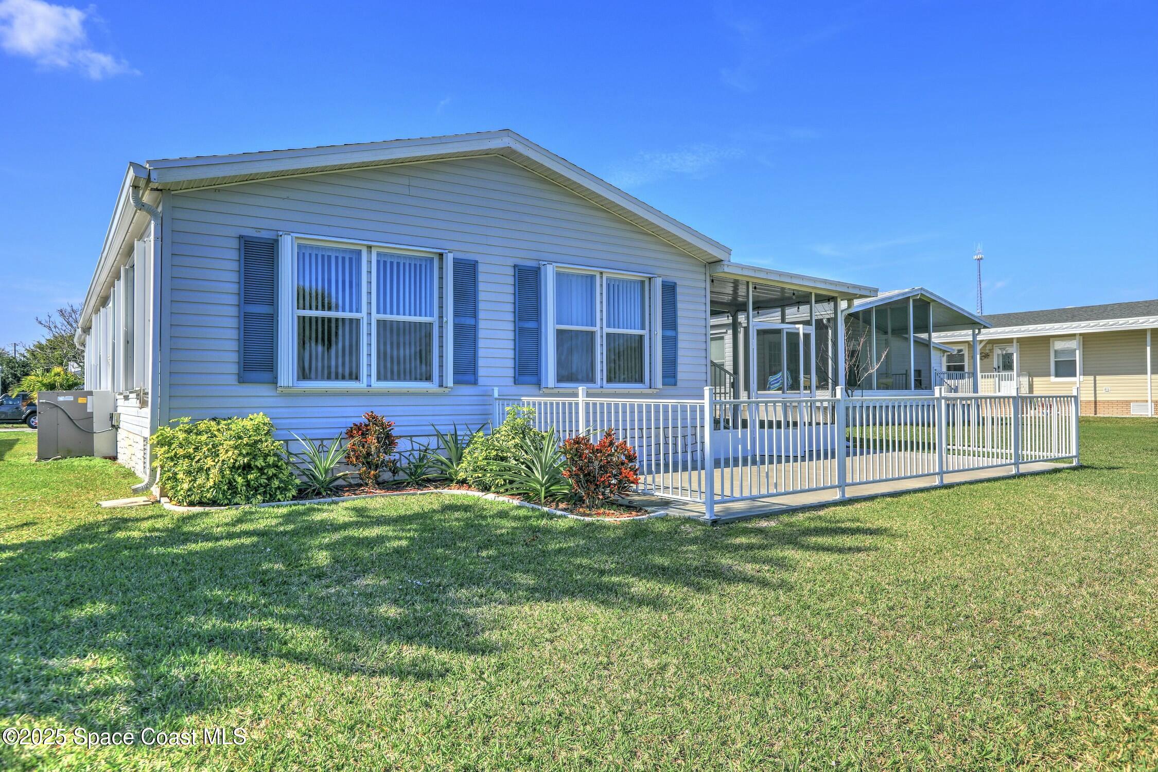 1124 Barefoot Circle Barefoot Bay, FL 32976 - Photo 27 of 79 a view of front of house with a yard