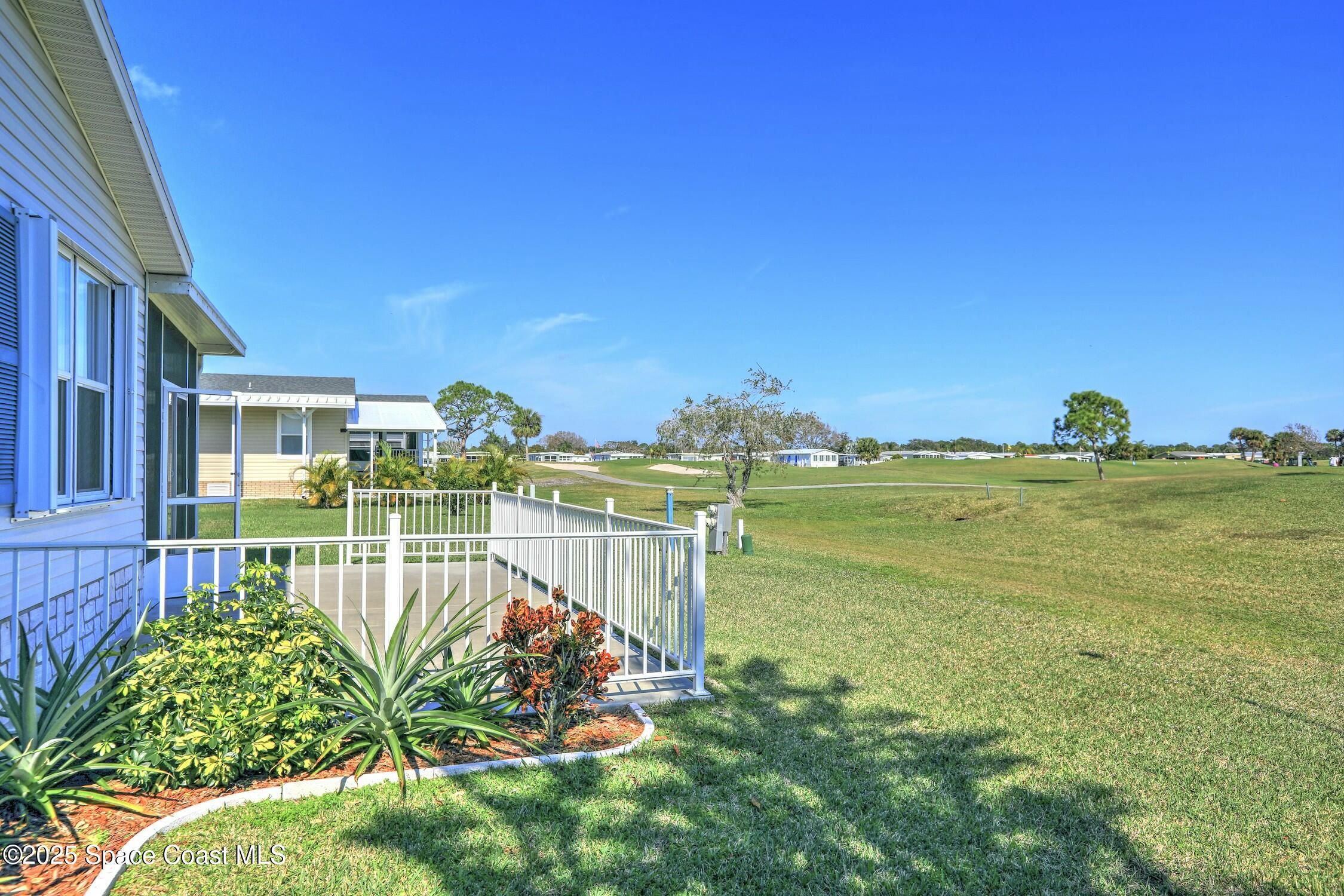 1124 Barefoot Circle Barefoot Bay, FL 32976 - Photo 28 of 79 a view of a swimming pool with a garden