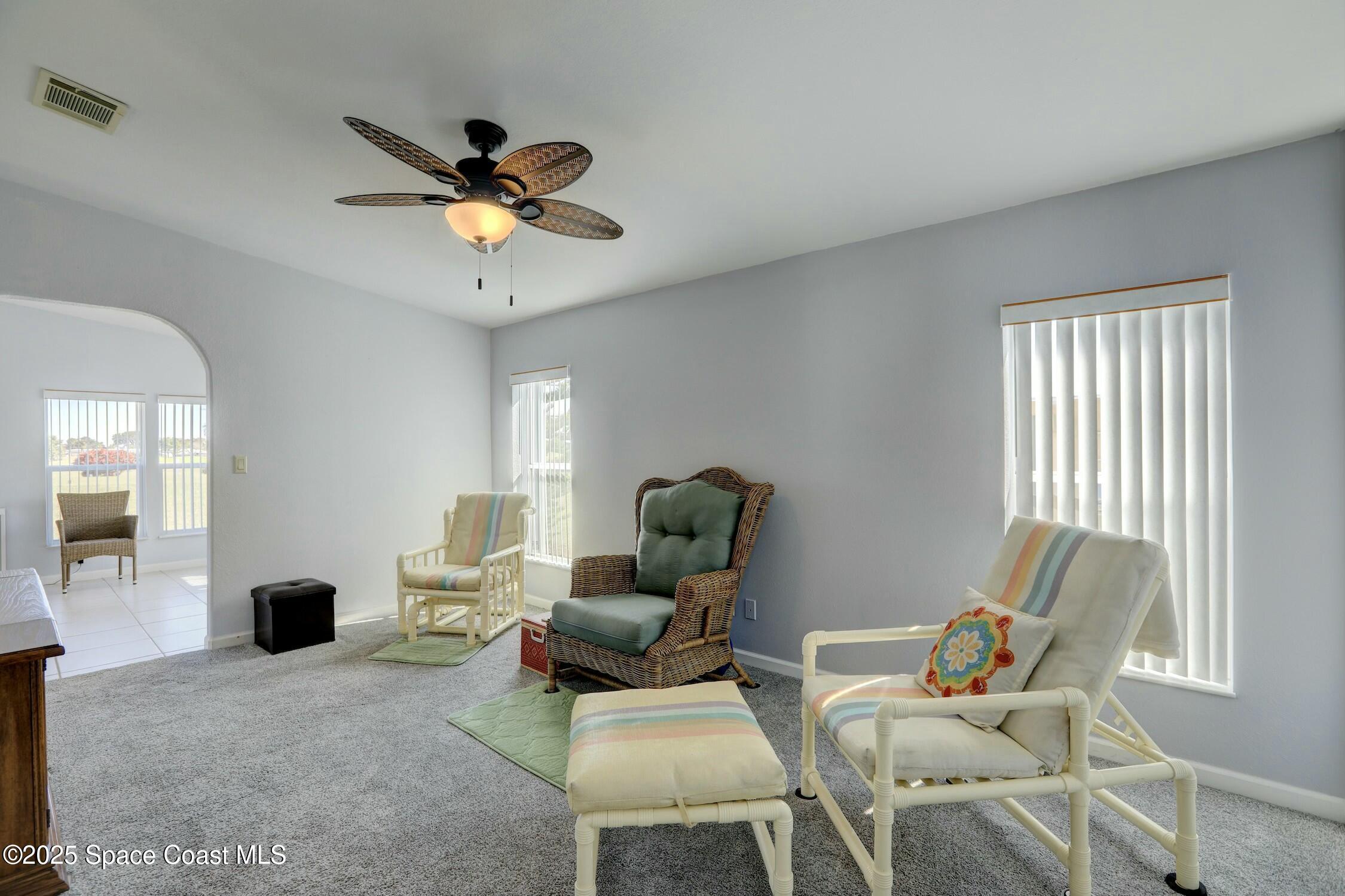1124 Barefoot Circle Barefoot Bay, FL 32976 - Photo 32 of 79 a living room with furniture and a ceiling fan