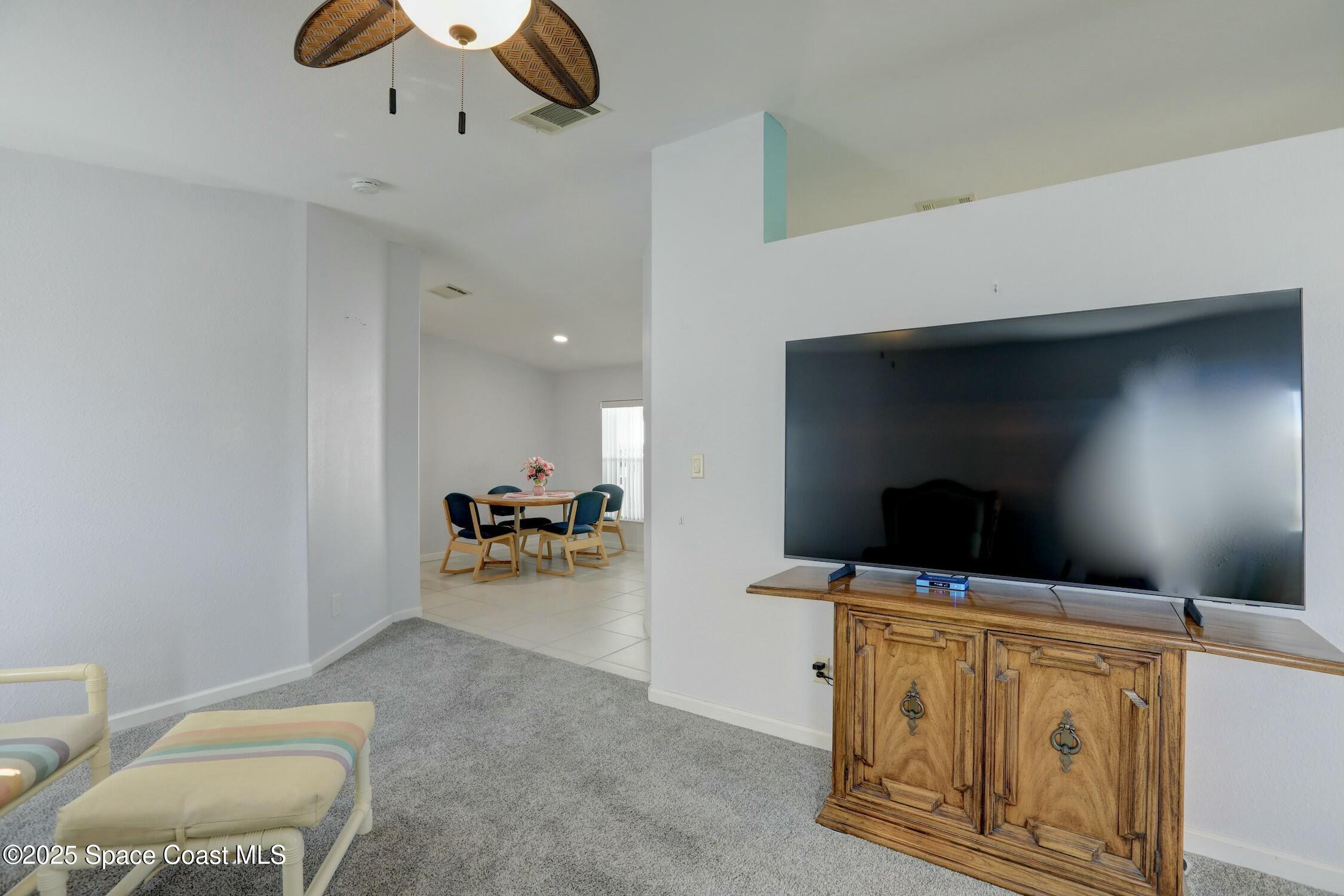 1124 Barefoot Circle Barefoot Bay, FL 32976 - Photo 35 of 79 a living room with furniture and flat screen tv