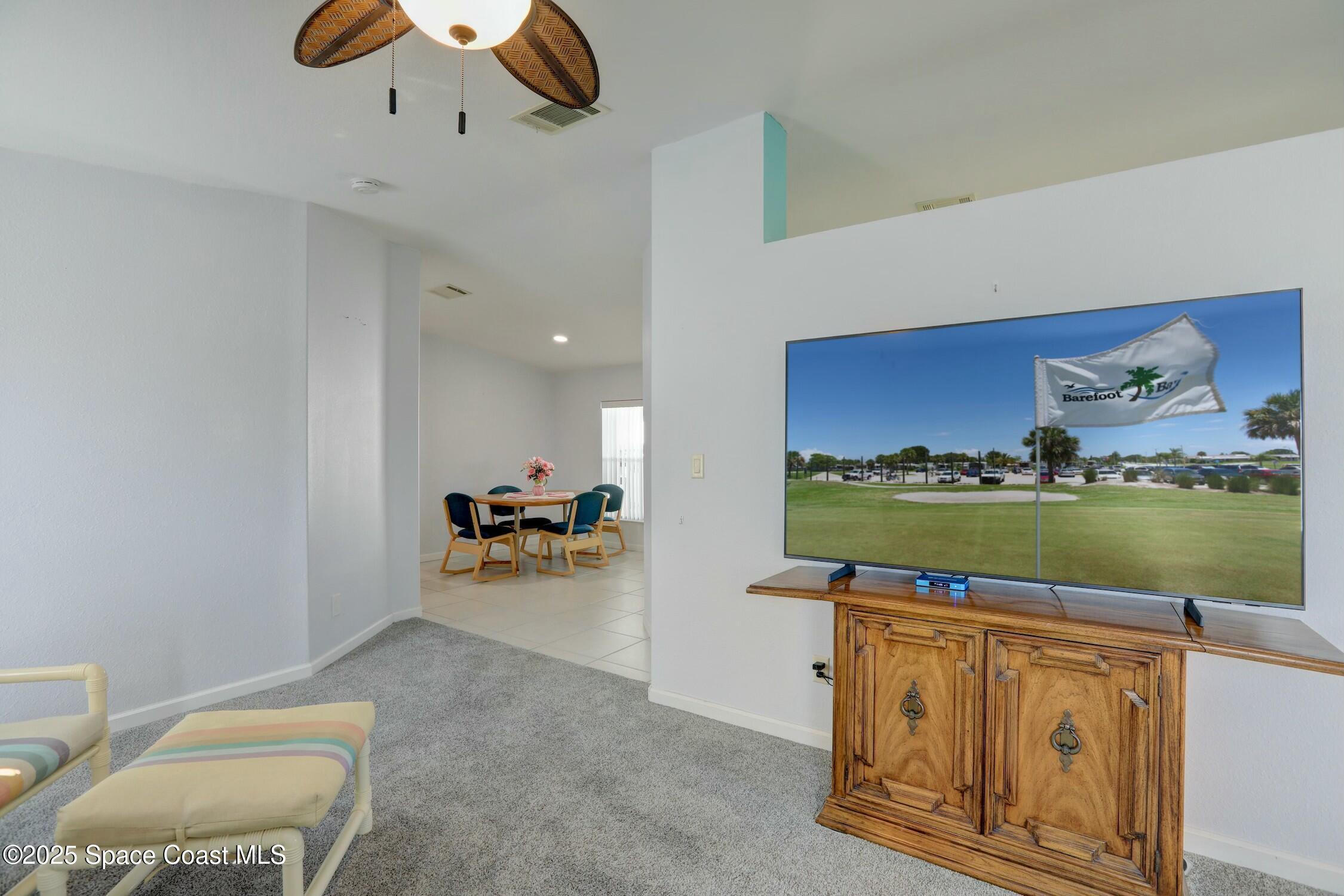 1124 Barefoot Circle Barefoot Bay, FL 32976 - Photo 36 of 79 a view of living room with furniture and floor to ceiling window
