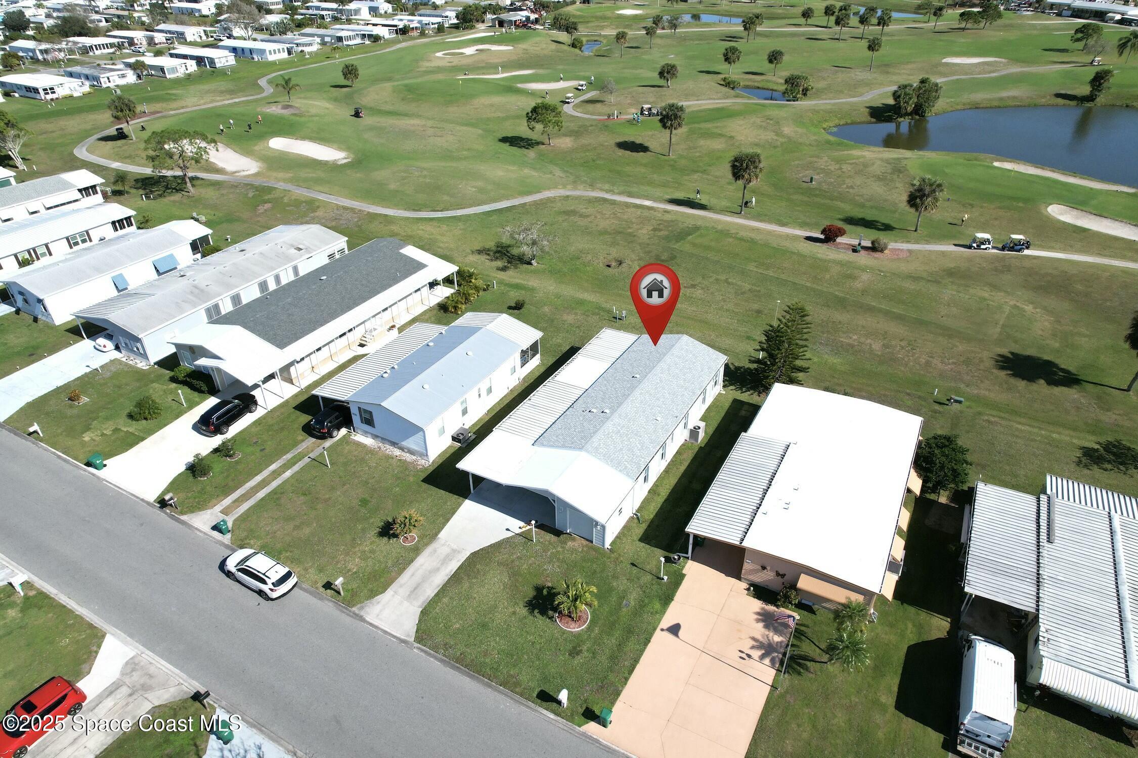 1124 Barefoot Circle Barefoot Bay, FL 32976 - Photo 4 of 79 an aerial view of a residential houses with outdoor space