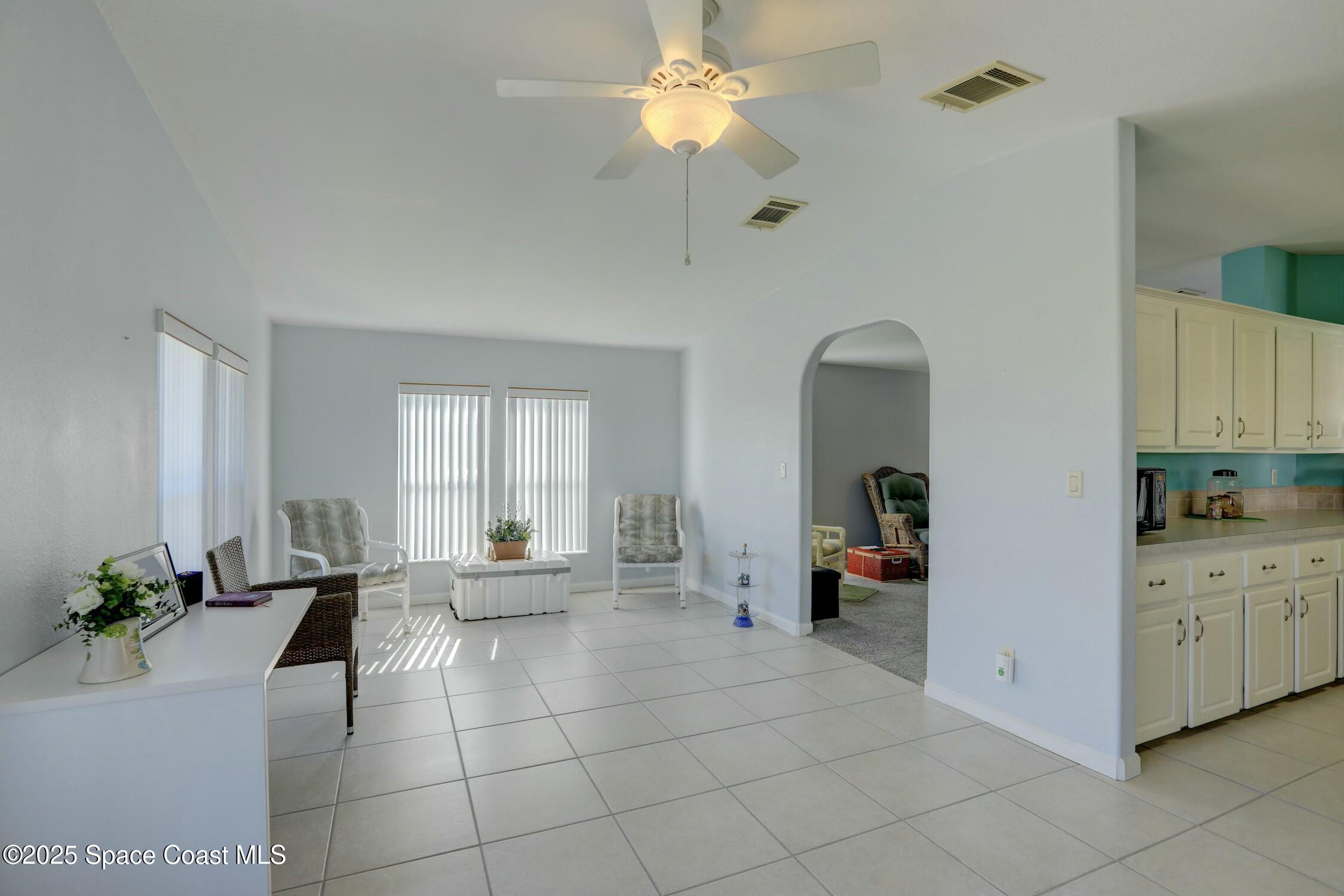 1124 Barefoot Circle Barefoot Bay, FL 32976 - Photo 43 of 79 a living room with furniture and a chandelier